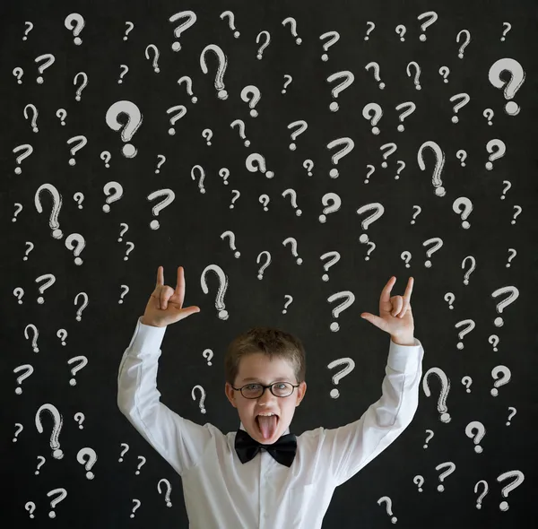 Education rocks boy dressed as business man with chalk question marks — Stock Photo, Image