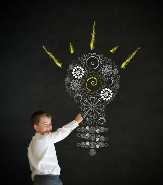 Writing boy dressed as business man with bright idea gear cog lightbulb — Stock Photo, Image