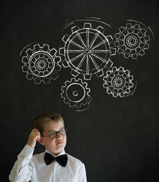 Scratching head thinking boy dressed as business man with chalk turning gear cogs or gears — Stock Photo, Image