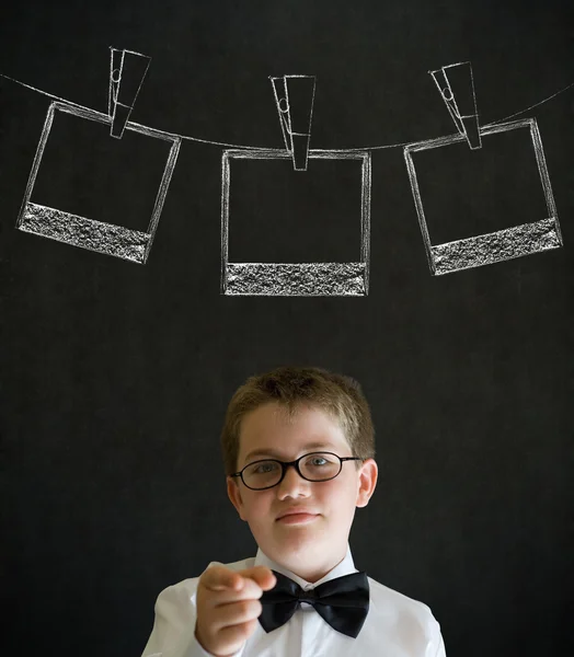 Boy with hanging instant photograph — Stock Photo, Image