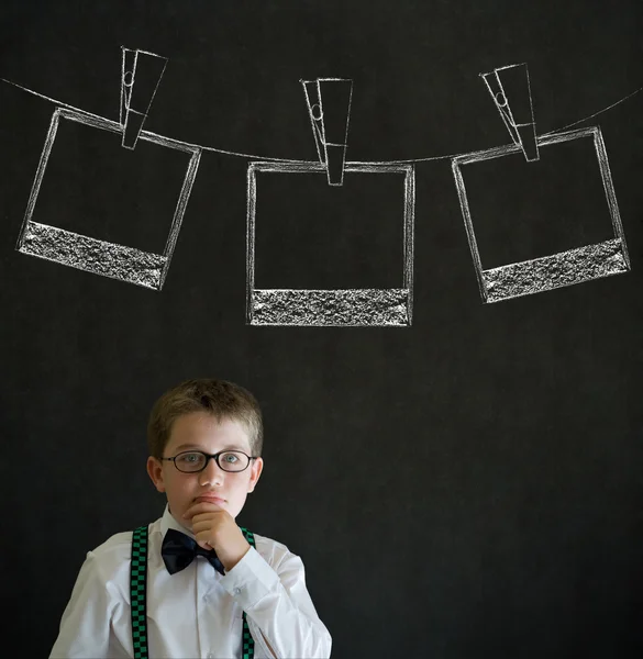 Thinking boy business man with hanging instant photo photograph on clothes line — Stock Photo, Image