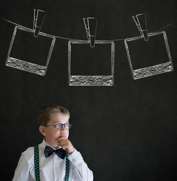 Thinking boy business man with hanging instant photo photograph on clothes line — Stock Photo, Image