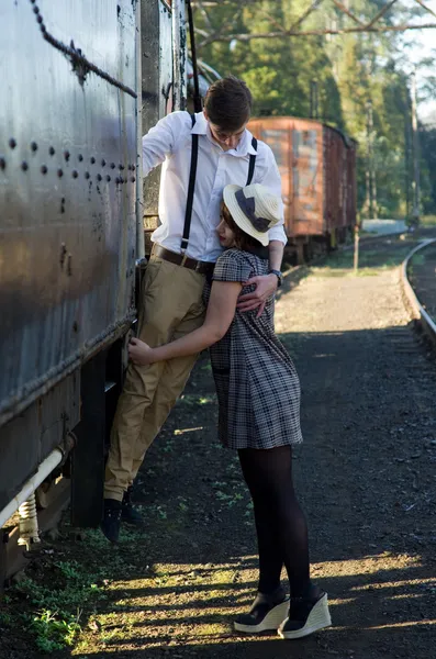 Retro young love couple vintage train setting — Stock Photo, Image