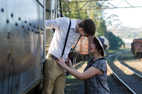 Retro young love couple vintage train setting — Stock Photo, Image