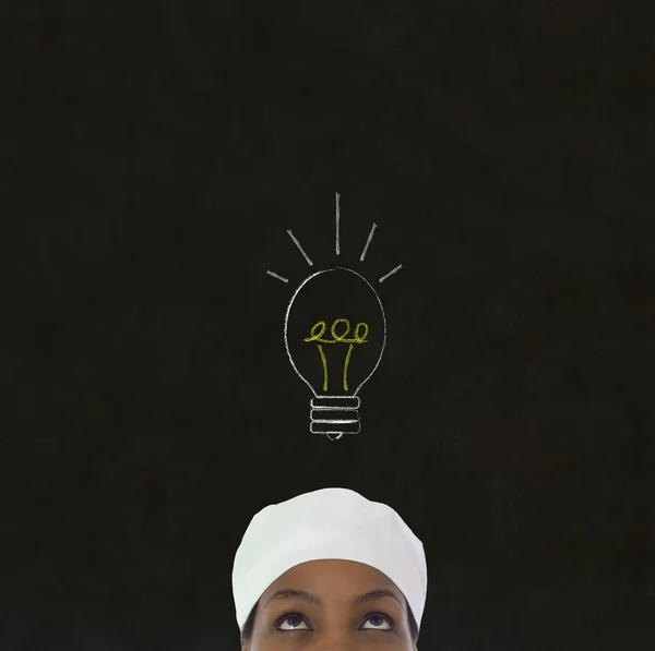 Lightbulb idea African woman chef on chalk blackboard background — Stock Photo, Image