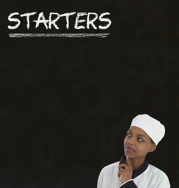 Chef with chalk starters sign on blackboard background — Stock Photo, Image