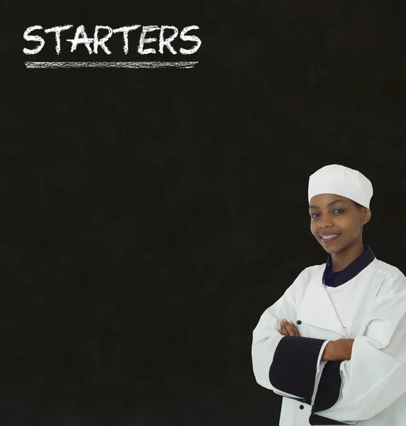 Chef with chalk starters sign on blackboard background — Stock Photo, Image