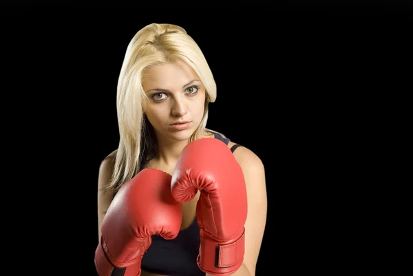 Beautiful young woman training with boxing gloves on blackboard background — Stock Photo, Image