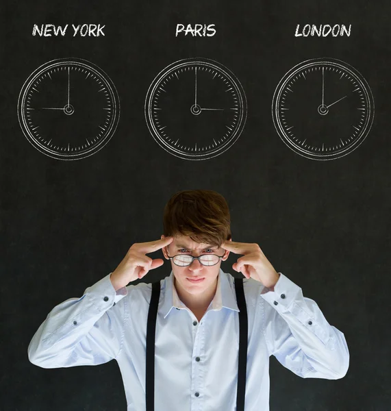 Businessman thinking with New York Paris and London chalk time zone clocks on blackboard background