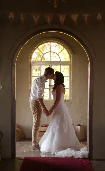 Novia y novio besándose dentro de la iglesia — Foto de Stock