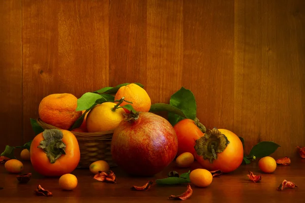 Persimmon, pomegranate and citrus fruits — Stock Photo, Image