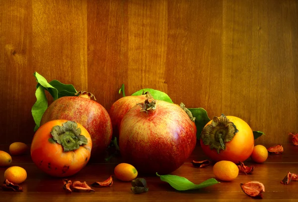 Persimmon, pomegranate and citrus fruits — Stock Photo, Image