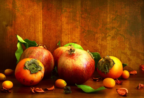 Persimmon, pomegranate and citrus fruits — Stock Photo, Image