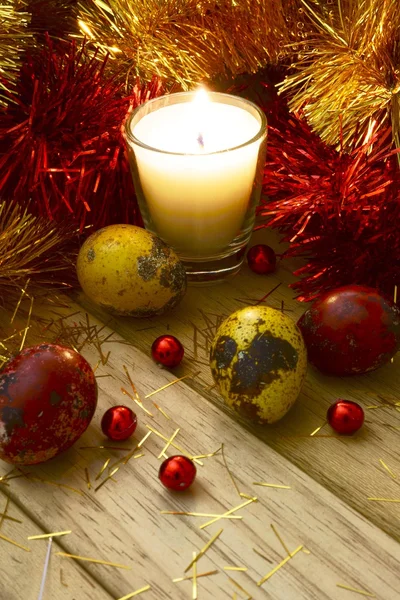 Tinsel and Easter eggs by candlelight — Stock Photo, Image