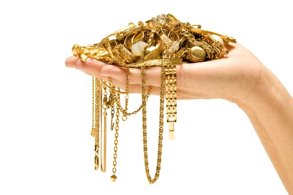 Hand som håller dyra guldsmycken Royaltyfria Stockbilder