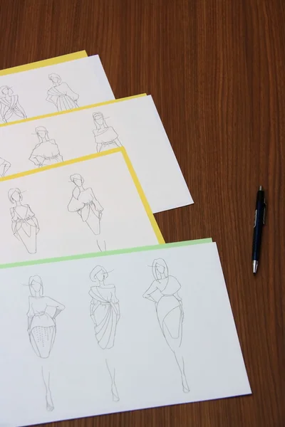 Designer assessing fashion drawings — Stock Photo, Image