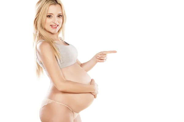 Pregnant woman showing direction — Stock Photo, Image