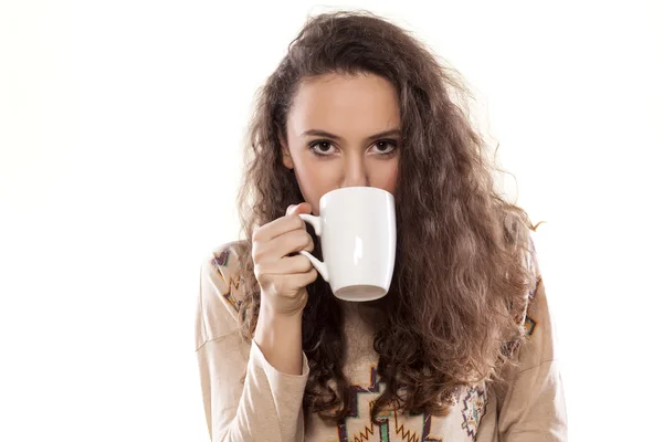 Girl drinking from a mug — Stock Photo, Image