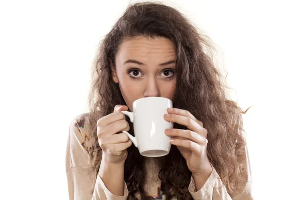 Girl drinking from a mug — Stock Photo, Image