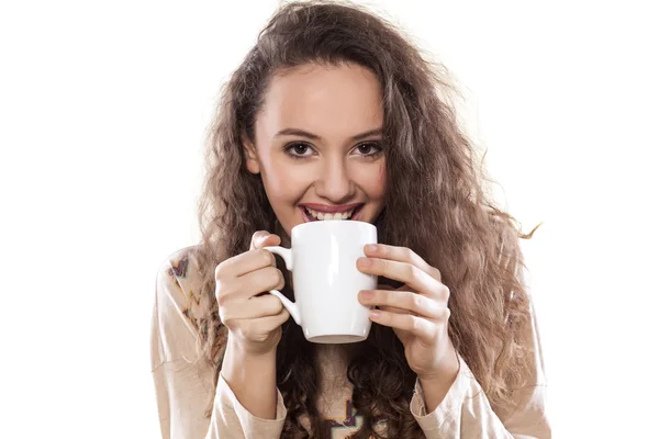 Girl drinking from a mug — Stock Photo, Image