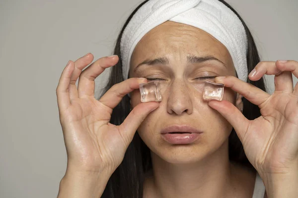 Young Woman Holding Ice Cubes Her Eyes Gray Background — Stock Photo, Image