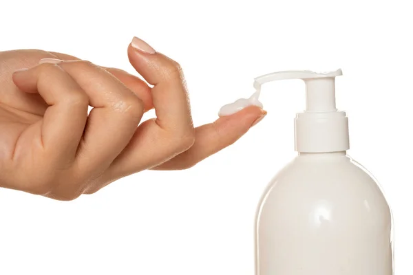 Bottle Cosmetic Product Pump Throws Cream Woman Finger White Background — Stock Photo, Image