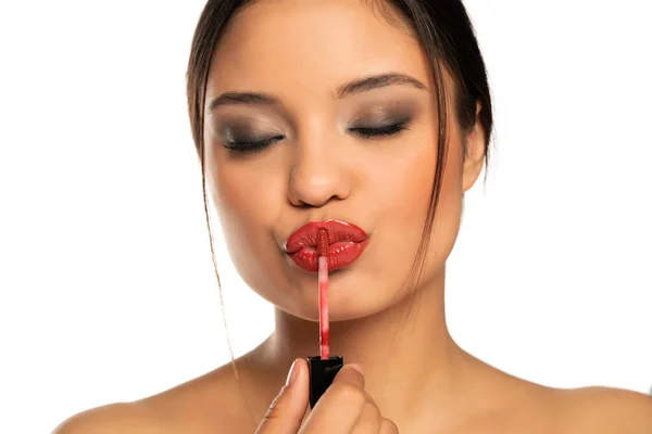 Closeup Young Beautiful Woman Applies Lip Gloss White Background — Stock Photo, Image