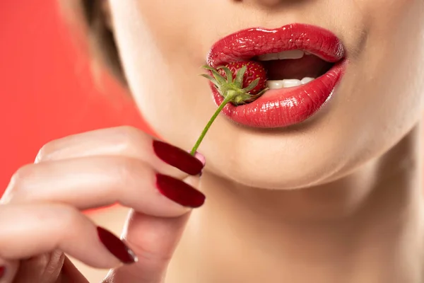 Female Lips Red Lipstick Holding Strawberry Her Teeth Red Background — Stock Photo, Image