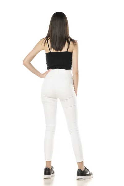 Vista Trasera Una Adolescente Jeans Blancos Una Camisa Negra Sobre —  Fotos de Stock
