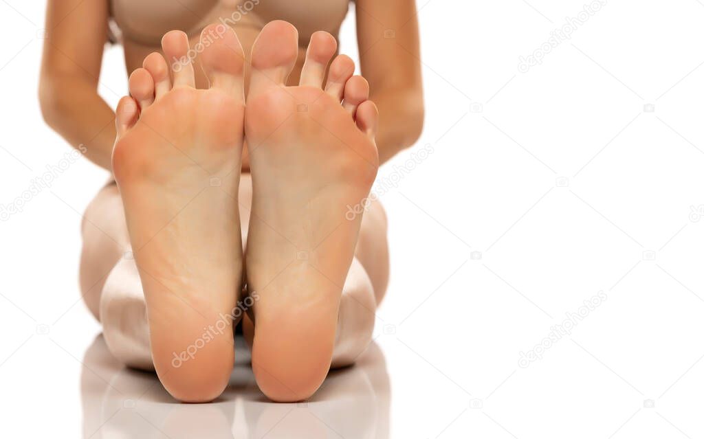Closeup shot of female feet isolated on white background