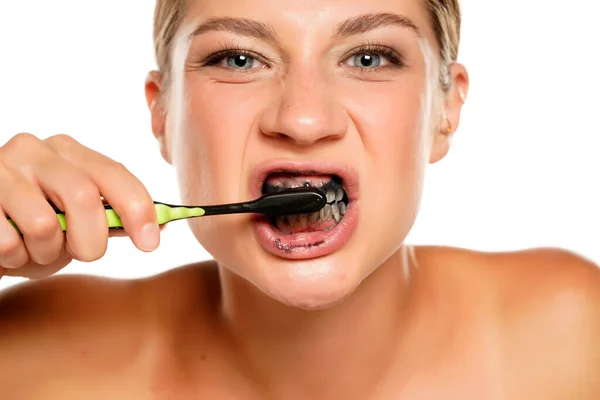 Happy Young Woman Brushing Her Teeth Black Charcoal Paste White — Stock Photo, Image