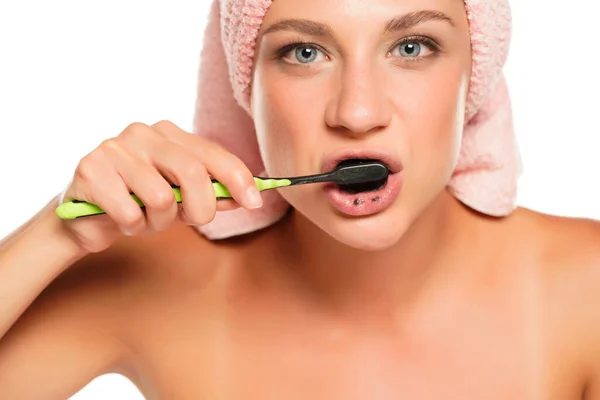 Young Woman Brushing Her Teeth Black Charcoal Paste White Background — Stock Photo, Image