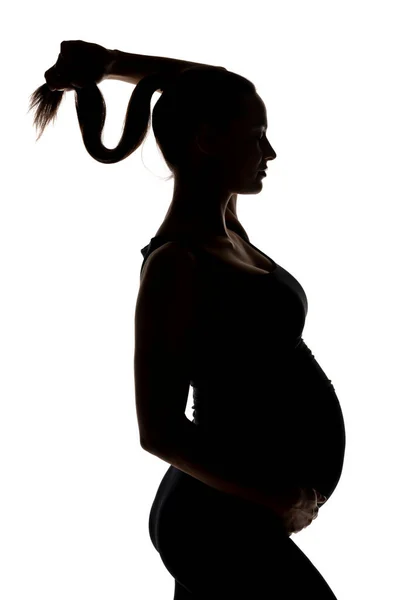 Silhouet Van Een Jonge Zwangere Vrouw Houdt Haar Paardenstaart Een — Stockfoto