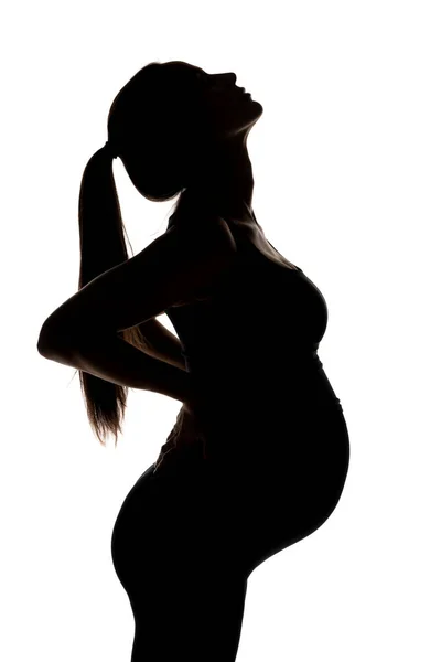 Silhouet Van Een Jonge Zwangere Vrouw Een Witte Achtergrond — Stockfoto