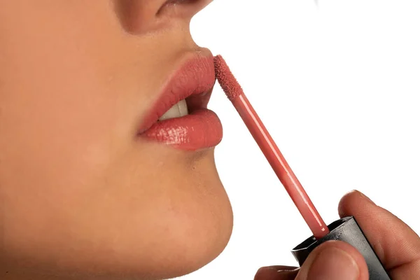 Closeup Woman Applying Lip Gloss Her Lips White Background — Stock Photo, Image