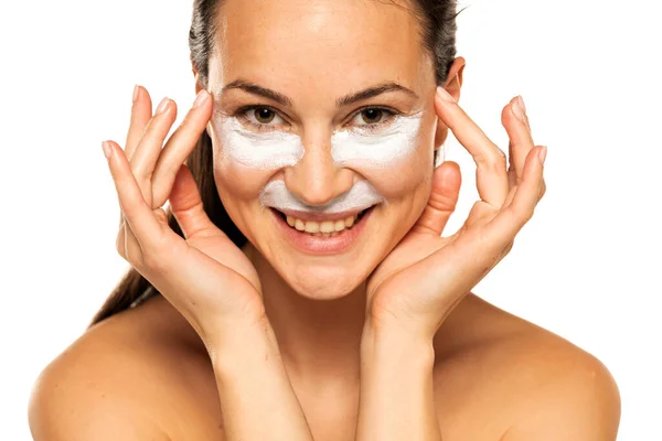 Młoda Szczęśliwa Kobieta Stosuje Produkt Kosmetyczny Pod Oczami Nosem Białym — Zdjęcie stockowe