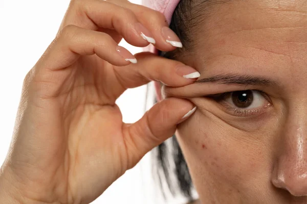 Middle Aged Woman Showing Her Eye Wrinkles Her Fingers White — Stock fotografie