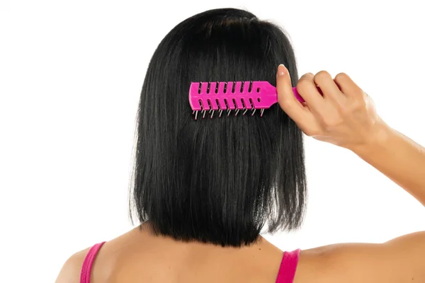 Woman Brushing Her Black Straight Hair White Background — Foto de Stock