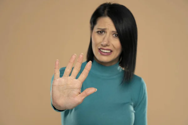 Nervous Woman Making Stop Gesture Her Hand Beige Background — Foto de Stock