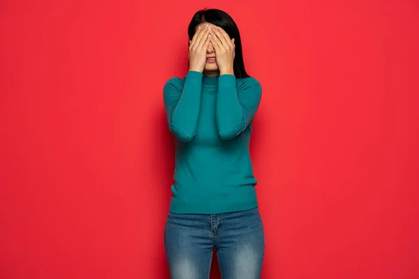 Young Woman Covering Her Eyes Her Hand Palms Red Background — ストック写真