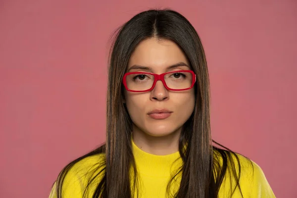 Portrait Young Serious Woman Yellow Blouse Red Glasses Pink Background — Stock Photo, Image