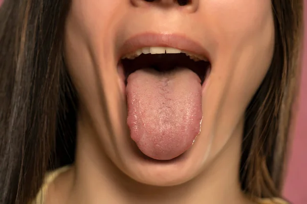 Front view of a woman tongue. close up