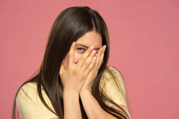 Beautiful Young Female Peeks Though Fingers Covers Face Both Hands — Foto Stock