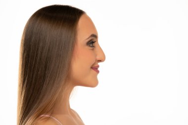 Profile face of young smiling woman on a white background.