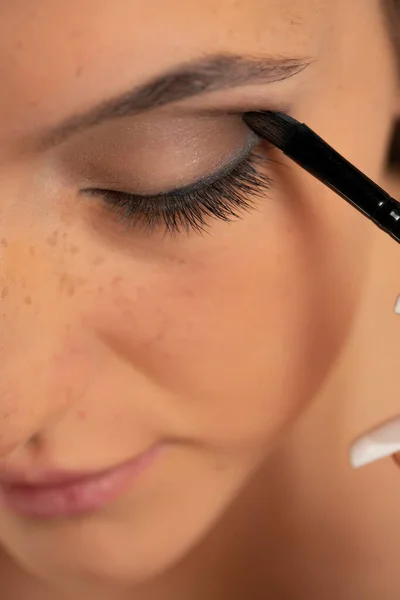 Close Young Woman Applying Eye Shadow Brush White Background — стоковое фото