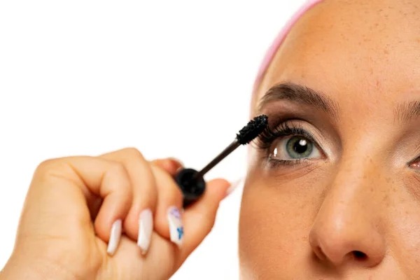 Closeup Woman Applying Mascara White Background — Stok Foto