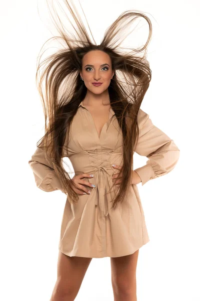 Young Woman Short Dress Long Flying Hair Standing White Background — Fotografia de Stock