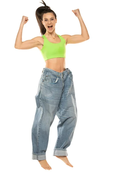 Diet Concept Weight Loss Happy Woman Oversize Jeans Jumping White — Stockfoto