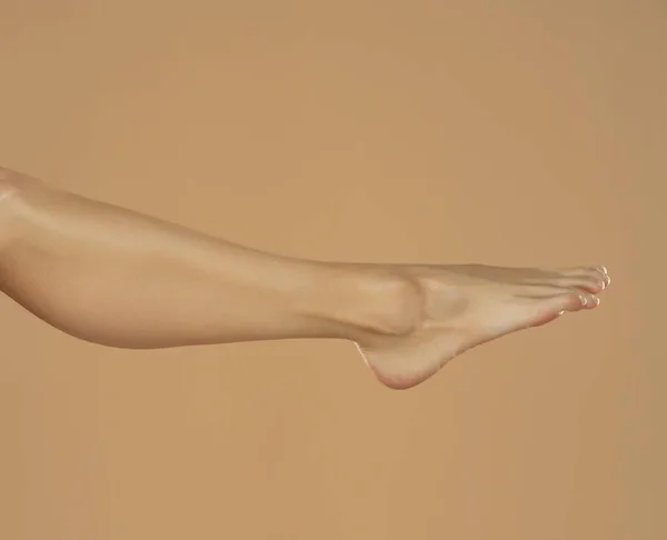 Female Leg Foot Isolated Beige Background — 图库照片