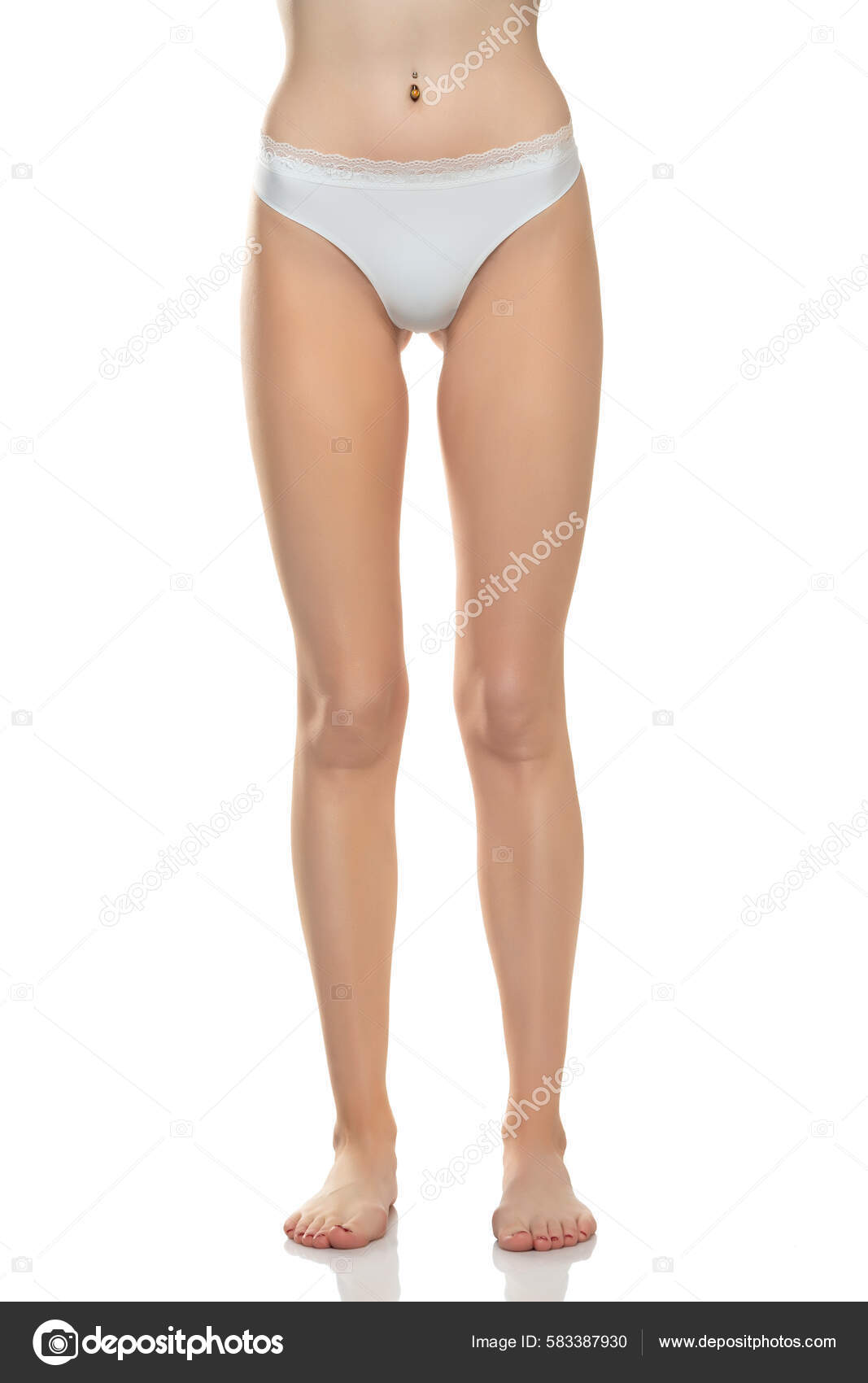 Mid section of woman wearing white briefs, front view on a blue background.  Stock Photo